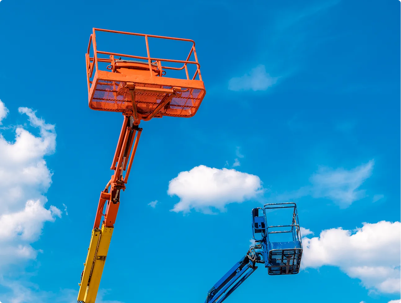 a yellow and blue lift with a blue sky in the background.